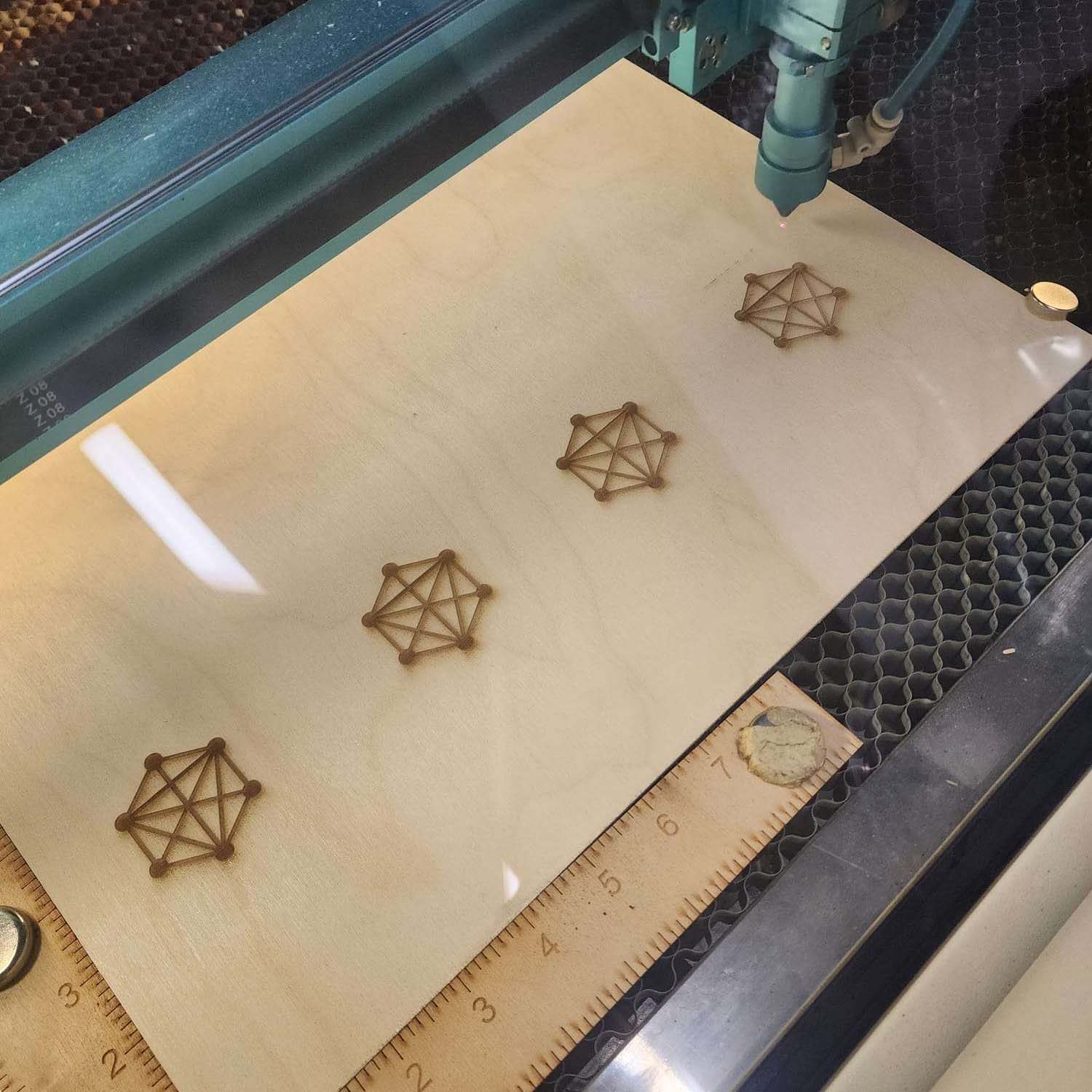 This is the process of the design being marked onto this wooden board, the IXD logo was just completed