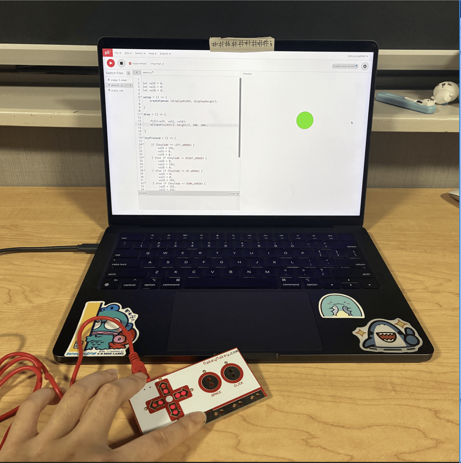 This was the first sketch where the user can change the colour of the square by clicking the arrow buttons, space button, and the 'click' button on the Makey Makey. This is an image of me using the Makey Makey to make the circle change colours from pink to green by clicking the right arrow button. 