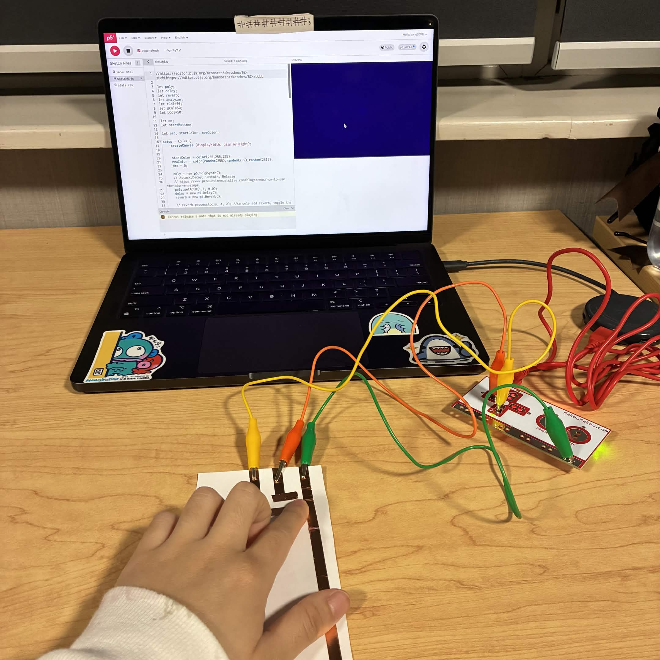 This is me connecting the down button circuit with my finger and how the p5js code reacts.