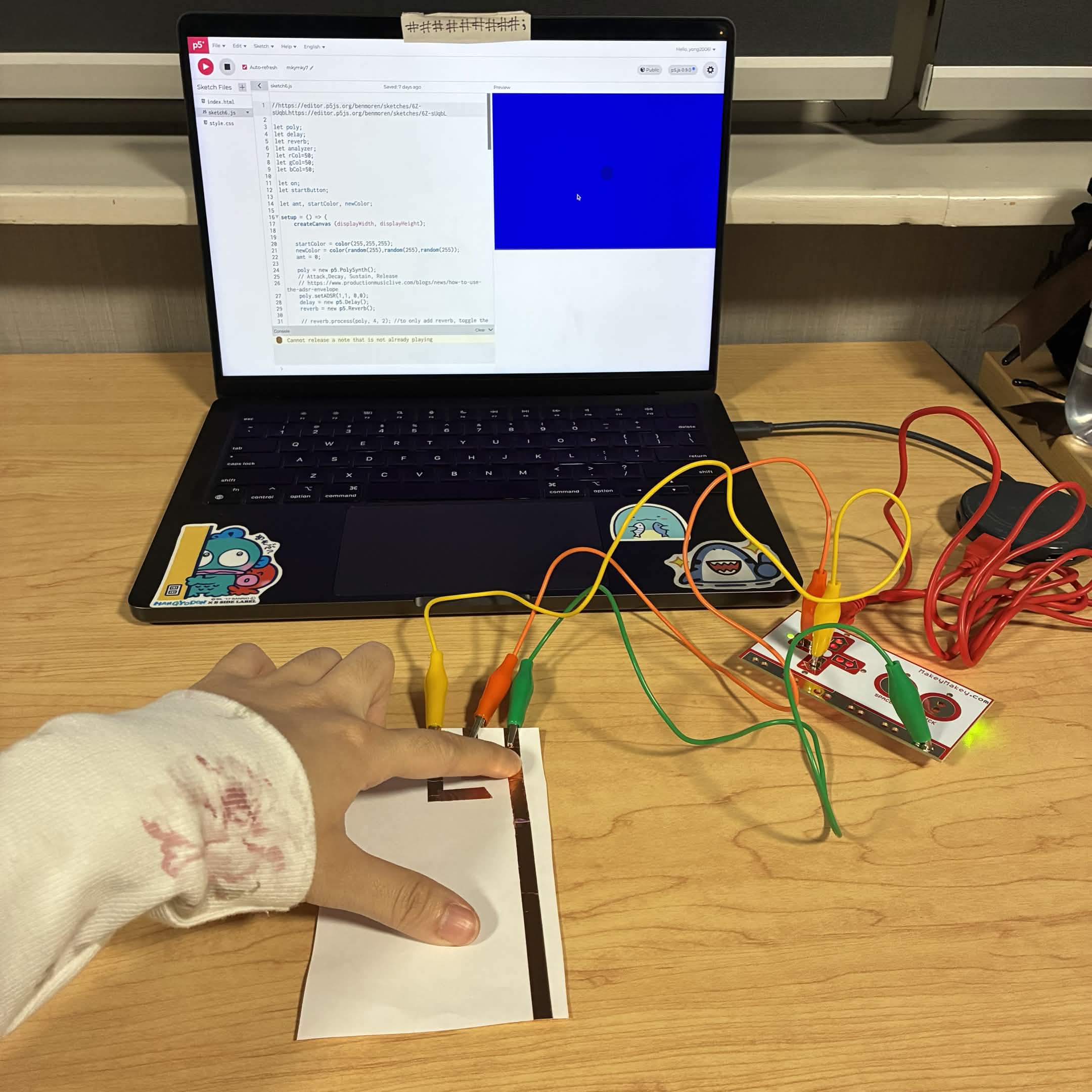 This is me connecting the left button circuit with my finger and how the p5js code reacts.